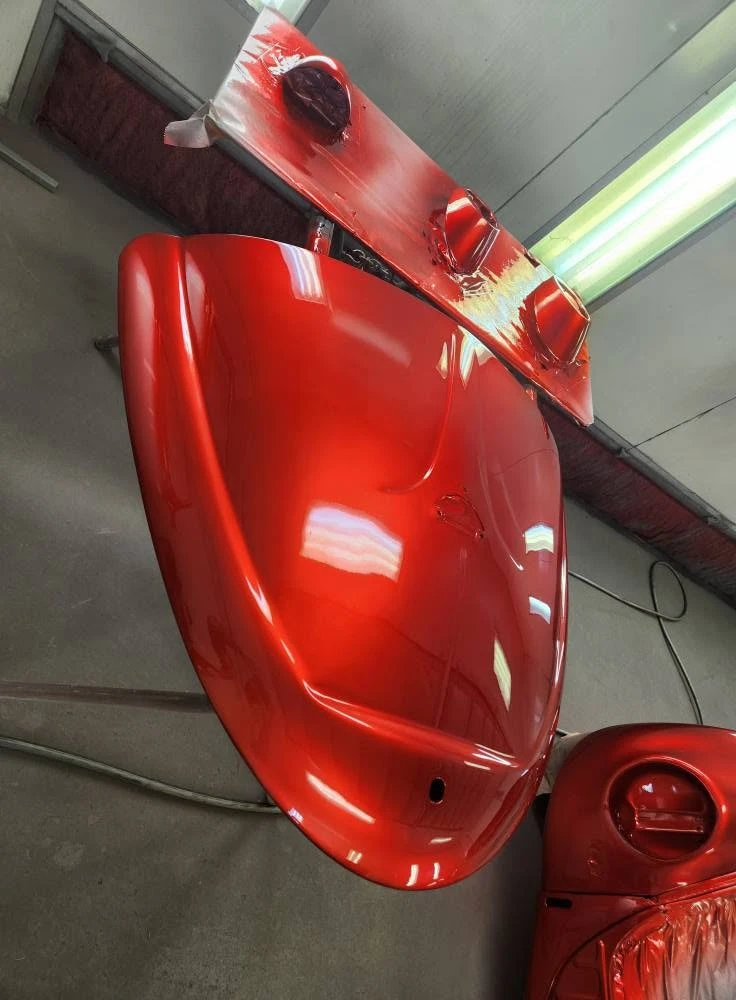 Red car panels being sprayed — Pigment to Panel Refinishing Cairns