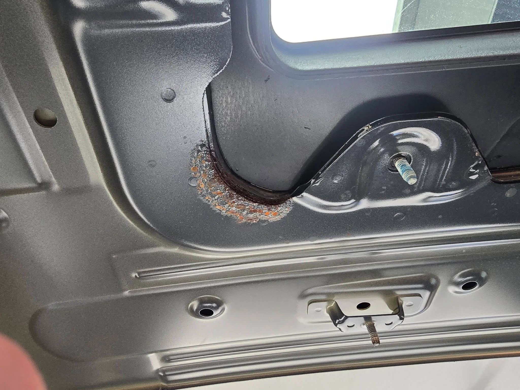 Rust spot on vehicle panel — panel repair Cairns